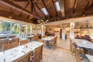 a restaurant with wooden ceilings and tables and chairs at Hotel Abalone in Crikvenica