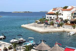 a marina with boats in the water next to buildings at Lavanda in Tribunj