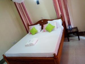um quarto com uma cama com um telefone em Savannah Luxury Apartment em Nairobi