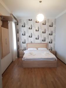 a bedroom with a bed and a wall with bottles at White House in Kakheti Eniseli in Gremi