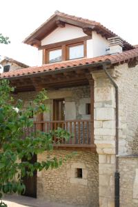 a house with a deck on the side of it at La Carriella in Colombres