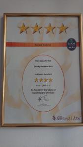 a framed diploma with four stars on a wall at Trinity Boutique B&B in Peterhead