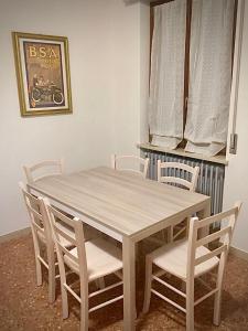 een houten tafel en stoelen in een kamer bij Villa Ferri in Peschiera del Garda