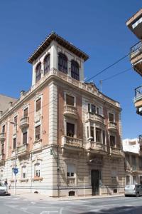 a large brick building on the corner of a street at Apartamento en Edificio Tortosa in Monóvar