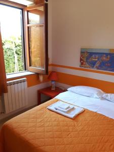 a bedroom with a bed with a towel on it at Villa le Due Palme in Isola delle Femmine