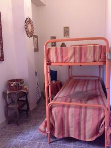 a bedroom with two bunk beds in a room at Attico Belvedere in Castellammare del Golfo