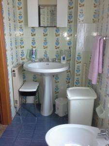 a bathroom with a sink and a toilet at Attico Belvedere in Castellammare del Golfo