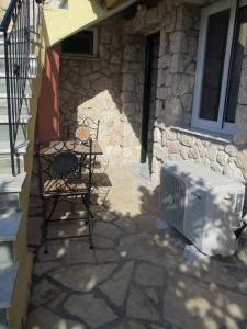 a microwave sitting on a patio next to a building at Korina Studios in Paleokastritsa