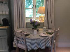 a table with a blue and white striped table cloth at Eydon B&B in Daventry