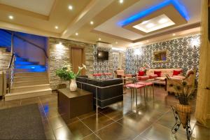 a living room with a couch and a table at Aigli Rooms in Leptokarya