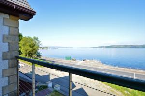 a view of the water from the balcony of a house at Clydeside Villa in Dunoon