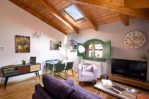 a living room with a couch and a table and a clock at Arbesa Huesca in Huesca