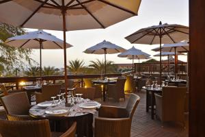 a restaurant with tables and chairs and umbrellas at Hotel Morabeza in Santa Maria
