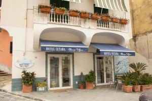 a building with blue awnings on the side of it at CETARA - ALBERGO DIFFUSO in Cetara