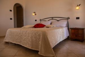 a bedroom with a bed with a white comforter at B&B Villa Italia in Agerola