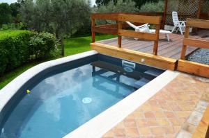 a swimming pool in a backyard with a deck at Bed and Breakfast Bike in Bagnoregio