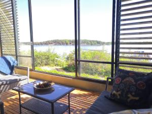 Apartment with sauna near the Saimaa lake في لابينرنتا: غرفة معيشة مع طاولة وإطلالة على الماء