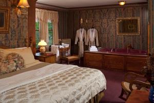 a bedroom with a bed and a bath tub at Old Rittenhouse Inn in Bayfield