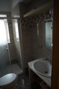 a bathroom with a shower and a toilet and a sink at Apartments SAB in Ogulin
