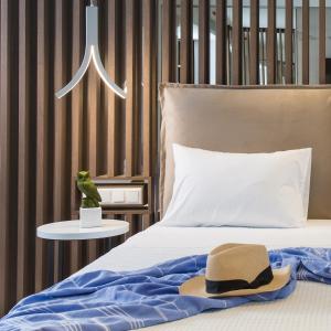 a hat sitting on top of a bed at Olympion Sunset Halkidiki in Fourka