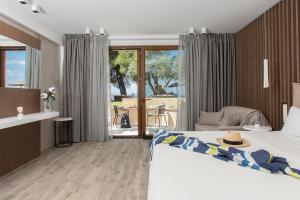a bedroom with a bed with a hat on it at Olympion Sunset Halkidiki in Fourka