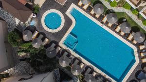an overhead view of a swimming pool with lounge chairs at Olympion Sunset Halkidiki in Fourka