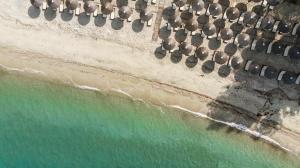 an overhead view of a beach with a bunch of chairs at Olympion Sunset Halkidiki in Fourka