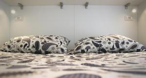 a bed with two pillows on top of it at L'ONDA 2 - Portovener-Fezzano in Fezzano