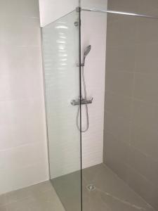 a shower with a glass door in a bathroom at Karem Bay in Kumak