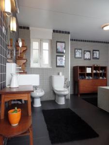 a bathroom with two toilets and a sink at Ponto de Vista - Coimbra in Coimbra