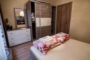 a bedroom with a bed with two towels on it at Sky Garden Apartment Burgas in Burgas