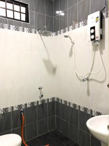 a bathroom with a shower and a sink at Family Homestay in Kuala Terengganu