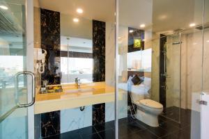 a bathroom with a toilet and a sink and a shower at Night Hotel in Hanoi +30 photos