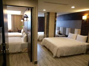 Postel nebo postele na pokoji v ubytování Maple Hotel
