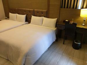 Postel nebo postele na pokoji v ubytování Maple Hotel
