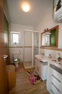 a bathroom with a shower and a sink and a toilet at Poseydon Beach Bungalow in Mlini