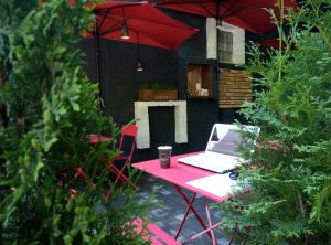 a red table with a laptop on top of it at Hostel Svit Hub in Kamianets-Podilskyi