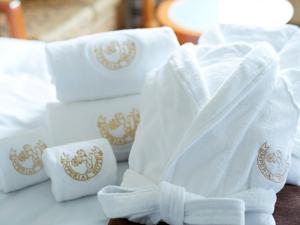 a pile of white towels with a crest on them at Imperial Hotel Osaka in Osaka