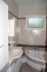 a bathroom with a sink and a bath tub at Villa St.George in Katerini +24 photos