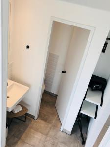 a bathroom with a sink and a toilet at gambino hotel CINCINNATI in Munich