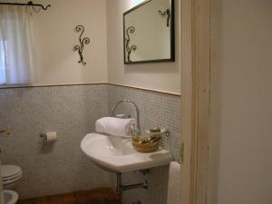 a bathroom with a sink and a toilet and a mirror at Valcastagno Relais in Sirolo