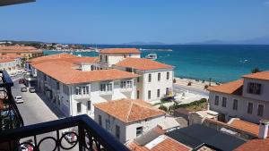 a view from a balcony of a town with the ocean at İleri Hotel & Apartments in Çeşme