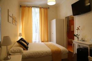 a bedroom with a bed and a large window at Dhome B&B in Rome