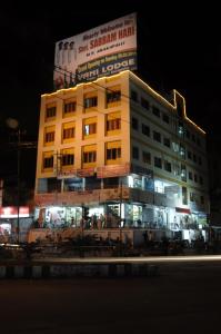 a building with a sign on top of it at night at Vani Lodge in Visakhapatnam