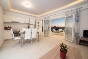 a kitchen and dining room with a view of the ocean at Bella Mare Luxury Apartments in Kalamaki