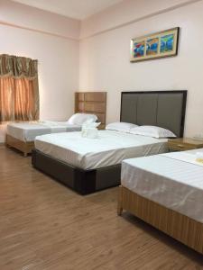 a hotel room with three beds in it at Meaco Royal Hotel - Lipa in Lipa +43 photos