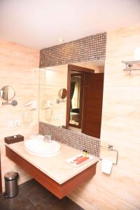 a bathroom with a sink and a mirror at Celesta - Kolkata in Kolkata