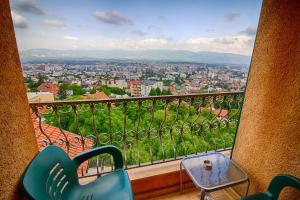 a view of a city from a balcony with a table and chairs at View Inn Boutique Hotel in Skopje