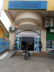 a motorcycle parked in front of a store at Asia Novo Boutique Hotel - Midsayap in Midsayap