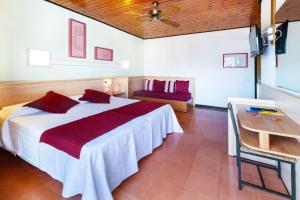 a bedroom with a bed and a table and a couch at Hotel Xaine Park in Lloret de Mar